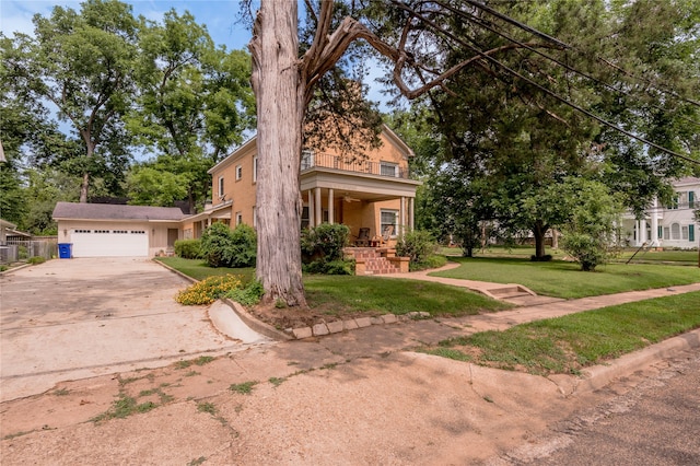 view of front of home with a garage, a front yard, and covered porch