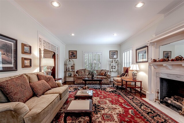 living room featuring a fireplace, wood-type flooring, and ornamental molding