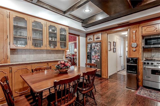 dining area featuring dark wood-type flooring and coffered ceiling