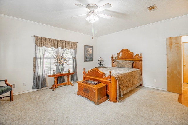 carpeted bedroom with ceiling fan and crown molding