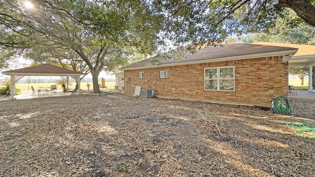 back of house with a gazebo, a patio, and central air condition unit