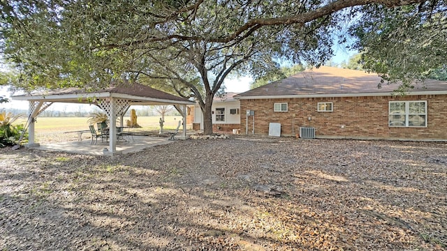 view of yard with a gazebo, cooling unit, and a patio