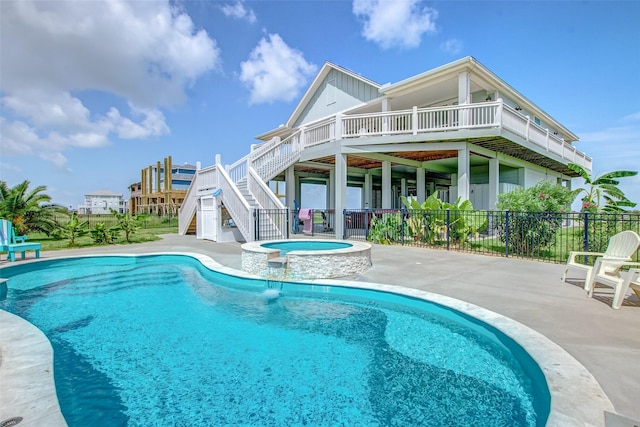 view of swimming pool featuring a deck, a patio area, and an in ground hot tub