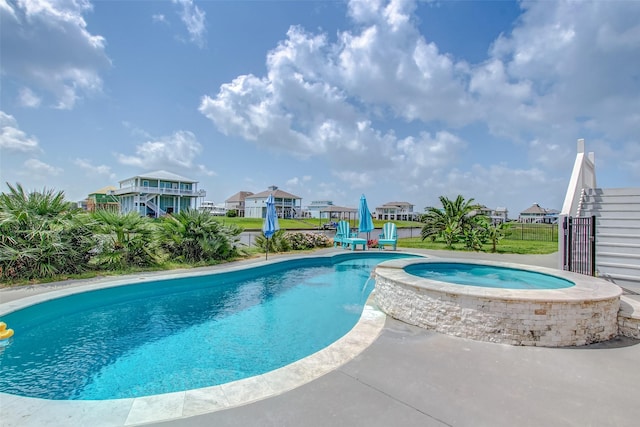 view of swimming pool featuring an in ground hot tub