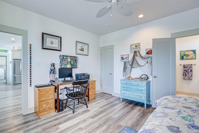 home office with ceiling fan and light hardwood / wood-style floors