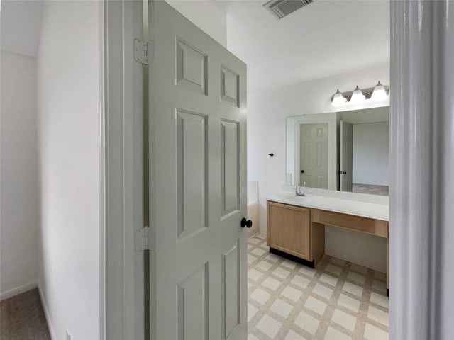 bathroom with tile patterned flooring and vanity