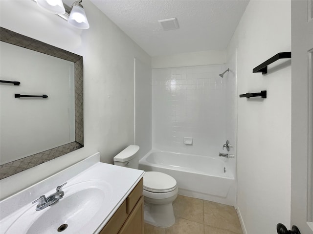 full bathroom featuring a textured ceiling, toilet, vanity, and tiled shower / bath