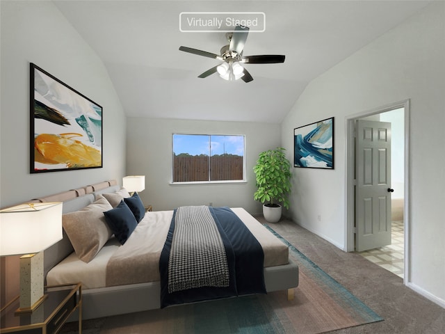 carpeted bedroom with ceiling fan and vaulted ceiling