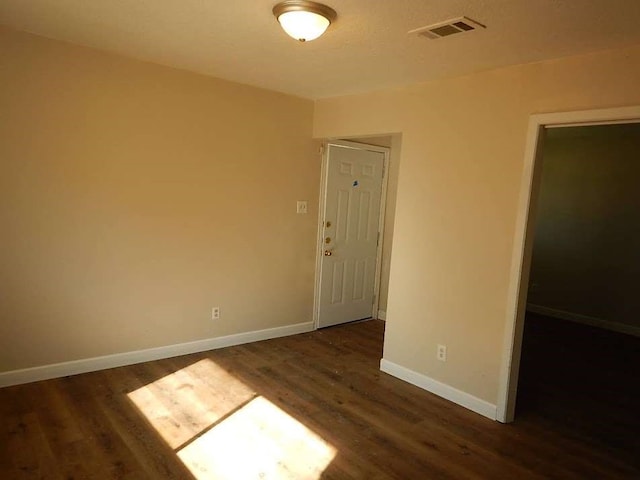 unfurnished room featuring dark hardwood / wood-style floors