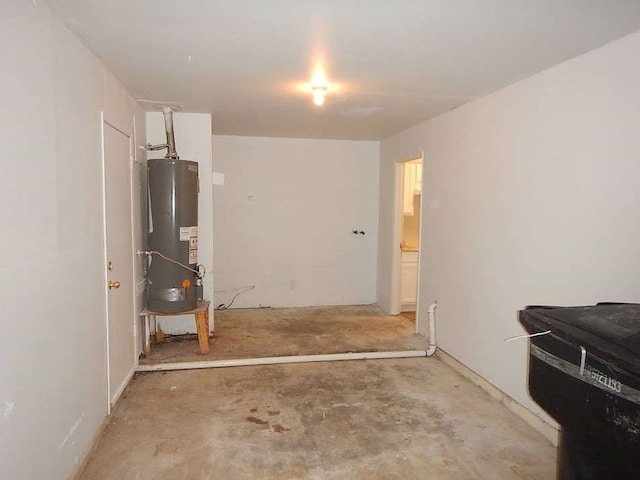 bedroom with concrete floors and gas water heater