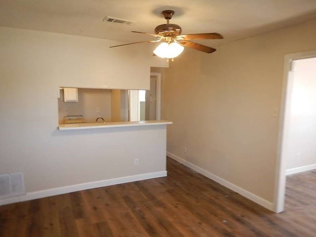 unfurnished room with dark wood-type flooring and ceiling fan