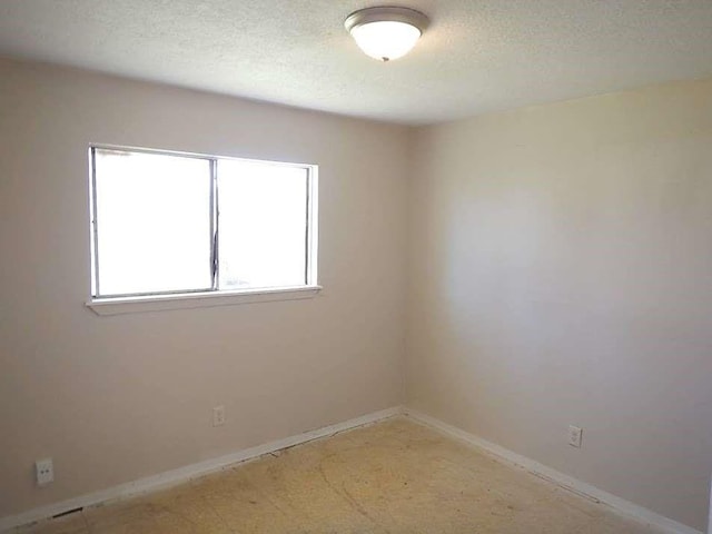 11503 Bay Cedar Dr, Houston, TX 77048 - spare room featuring a textured ceiling, baseboards, and light carpet