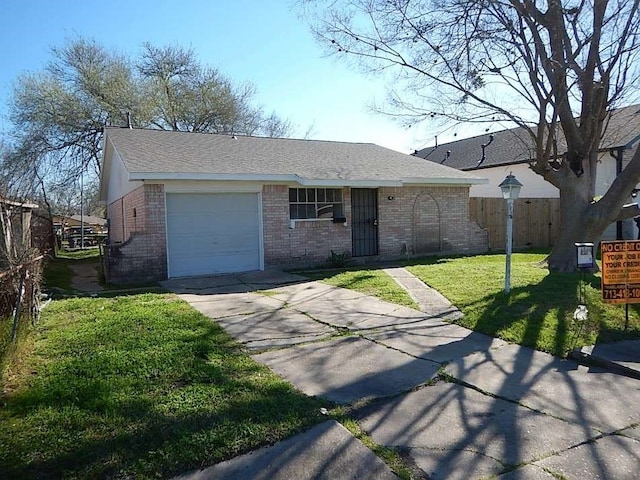 single story home with a garage and a front lawn