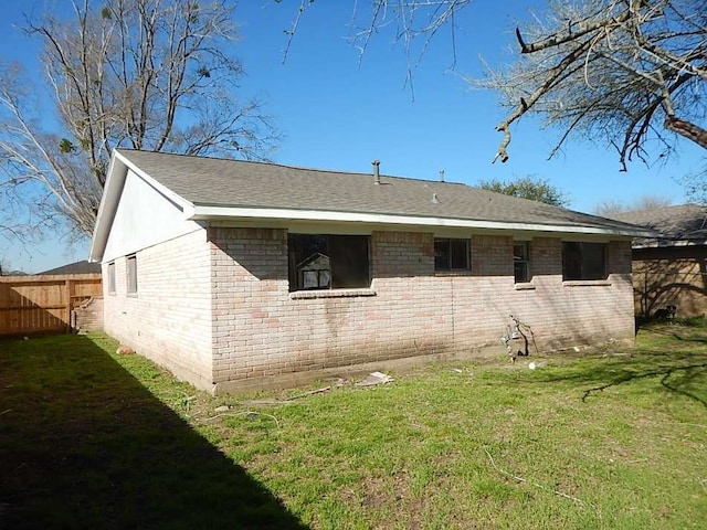 view of side of property with a lawn