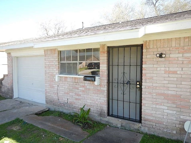 doorway to property featuring a garage