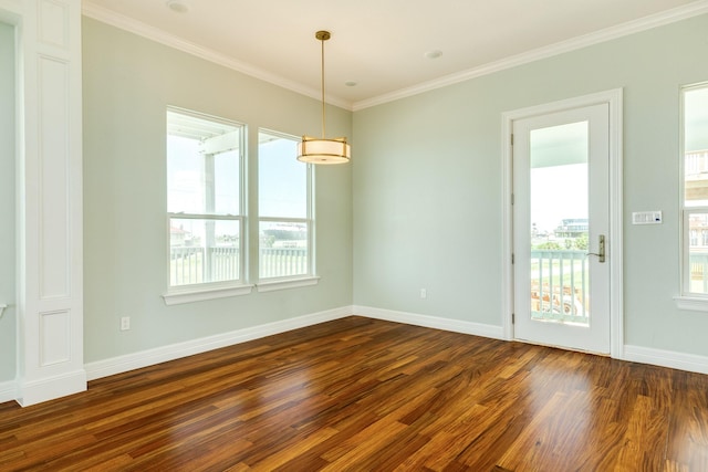 unfurnished room with dark hardwood / wood-style floors, ornamental molding, and a healthy amount of sunlight