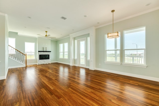 unfurnished living room with ceiling fan, dark hardwood / wood-style floors, crown molding, and a fireplace