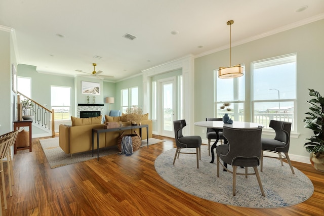 dining area featuring ceiling fan, ornamental molding, and hardwood / wood-style flooring