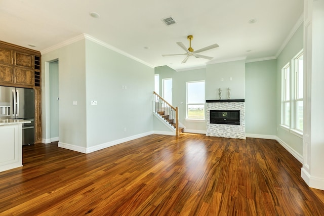 unfurnished living room with a fireplace, dark hardwood / wood-style flooring, ornamental molding, and ceiling fan