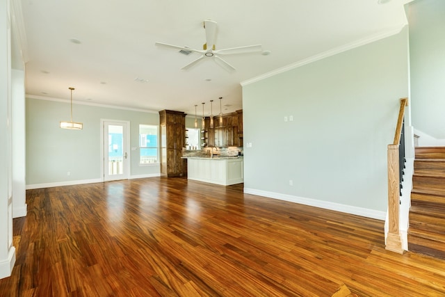 unfurnished living room with ceiling fan, dark hardwood / wood-style floors, and ornamental molding