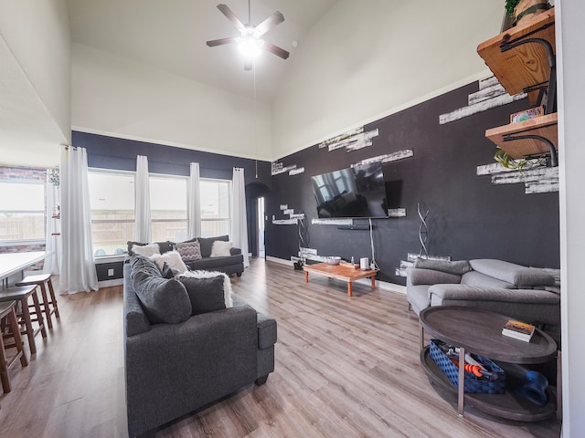 living room with high vaulted ceiling, ceiling fan, and hardwood / wood-style floors