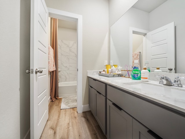 bathroom with hardwood / wood-style flooring, dual bowl vanity, and shower / bath combination with curtain