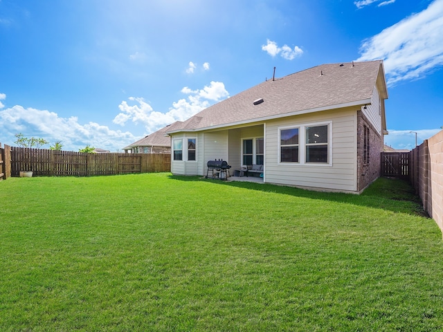 back of house with a yard and a patio area