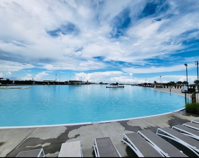 view of pool featuring a water view