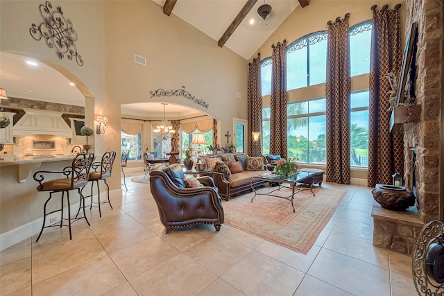 tiled living room with high vaulted ceiling and a chandelier