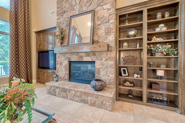 living room with light tile patterned flooring, a fireplace, and a wealth of natural light