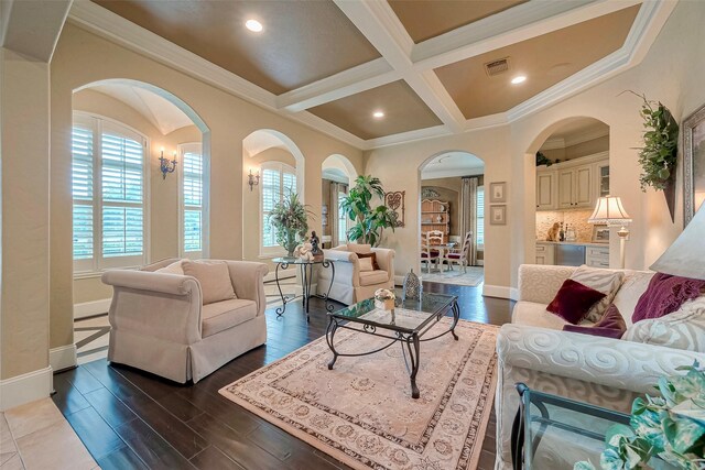 living room with ornamental molding, beam ceiling, hardwood / wood-style floors, and coffered ceiling