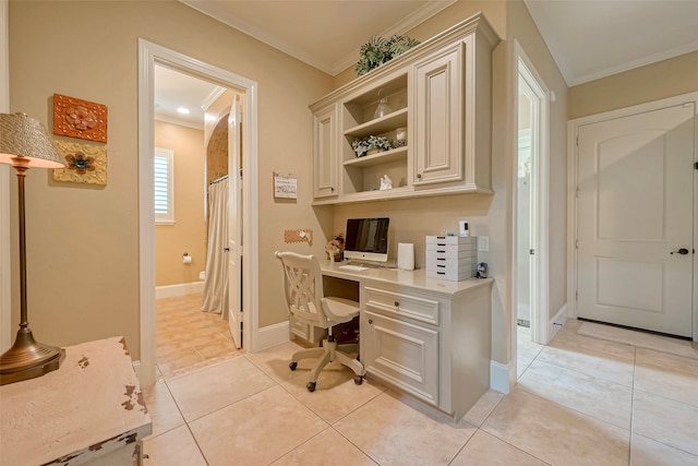 office with built in desk, light tile patterned floors, and ornamental molding