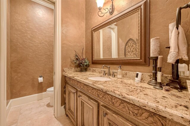 bathroom with tile patterned floors, toilet, and vanity