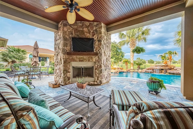 view of patio featuring pool water feature, an outdoor living space with a fireplace, and ceiling fan