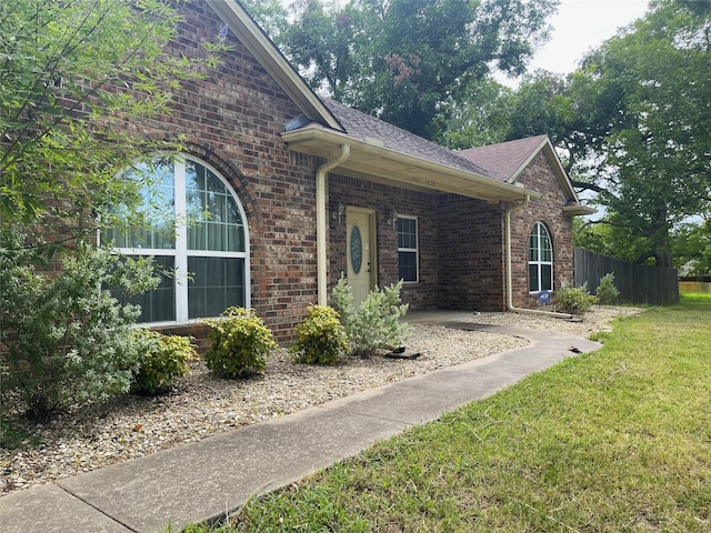 view of side of home with a yard