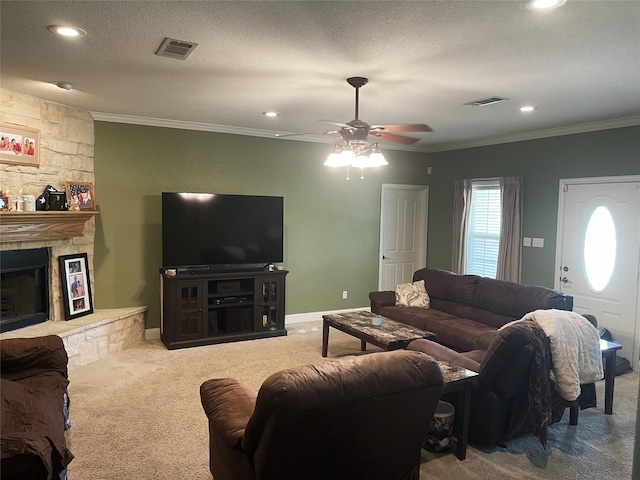 living room with carpet, crown molding, a stone fireplace, and a textured ceiling