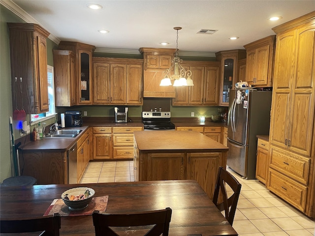 kitchen featuring decorative light fixtures, a kitchen island, light tile patterned floors, and appliances with stainless steel finishes