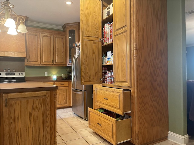 kitchen with crown molding, light tile patterned flooring, hanging light fixtures, and appliances with stainless steel finishes