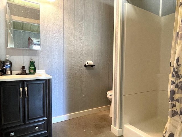 bathroom with vanity, wooden walls, toilet, a shower with shower curtain, and concrete flooring