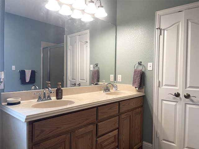 bathroom with a shower with door and vanity