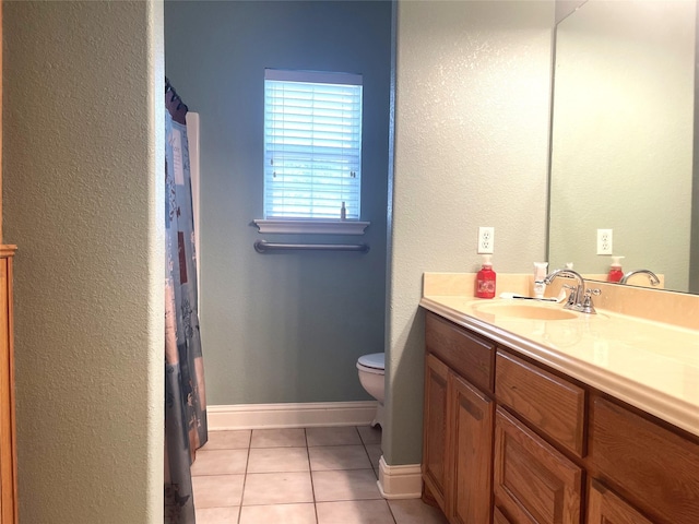 bathroom featuring tile patterned floors, vanity, and toilet