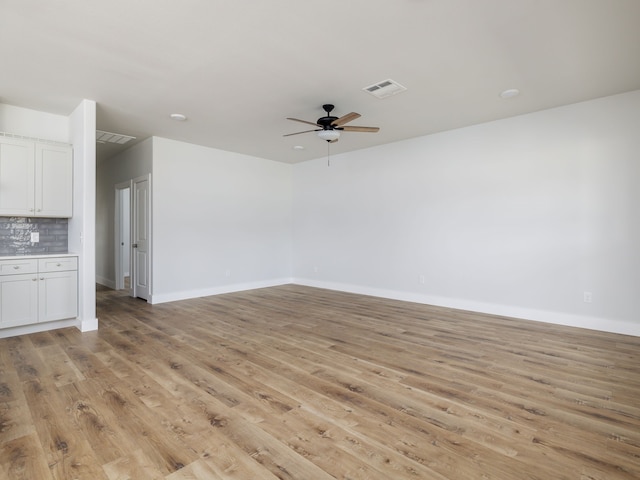 unfurnished living room featuring ceiling fan and light wood-type flooring