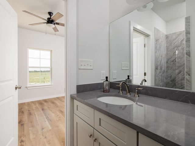 bathroom featuring vanity, ceiling fan, and wood-type flooring