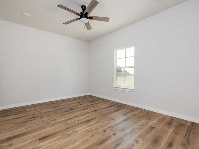 empty room with hardwood / wood-style flooring and ceiling fan