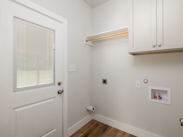 clothes washing area with hookup for a washing machine, hardwood / wood-style flooring, electric dryer hookup, and cabinets