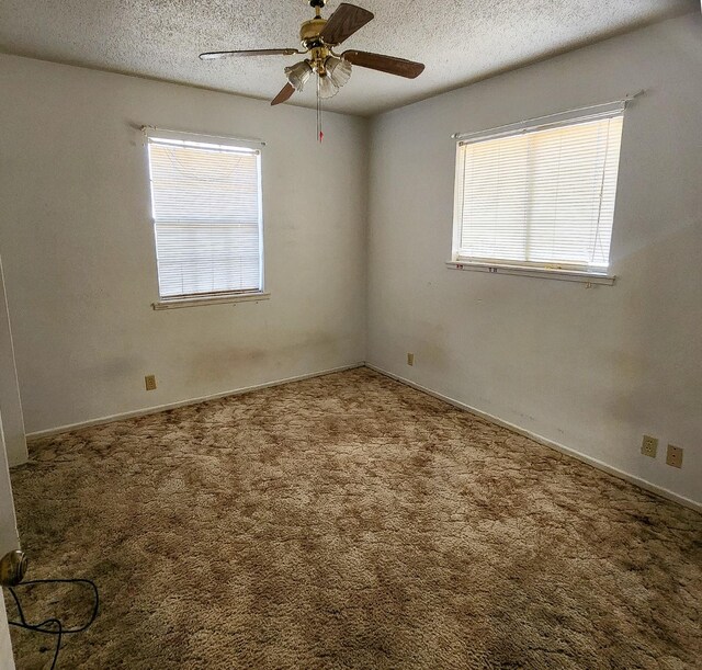 empty room with carpet, a textured ceiling, and ceiling fan