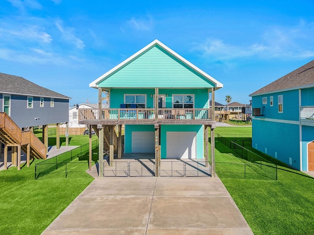 beach home featuring a garage, covered porch, and a front lawn