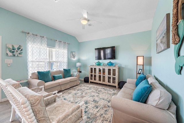 living room featuring lofted ceiling, ceiling fan, and light hardwood / wood-style flooring