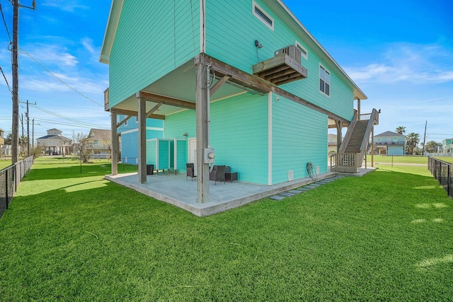 back of house featuring a yard and a patio