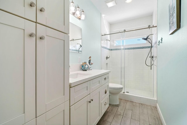 bathroom featuring vanity, toilet, and an enclosed shower